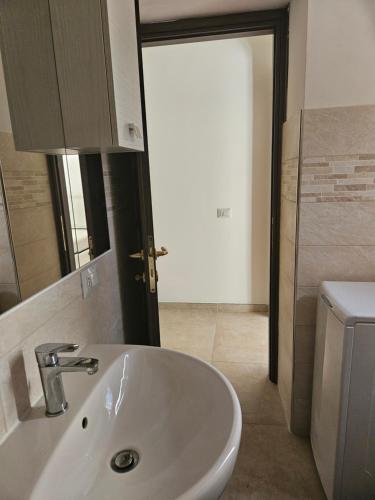 a bathroom with a white sink and a toilet at Holiday home Virginia in Nemi