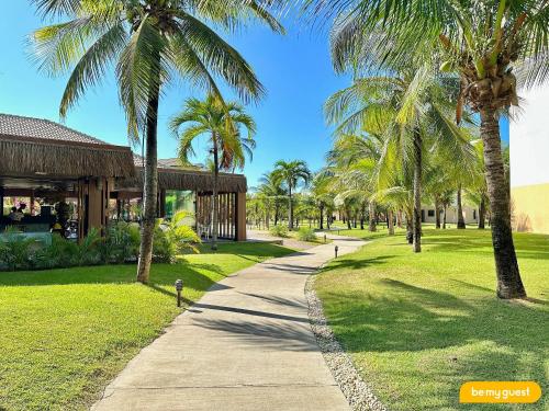 a path through a park with palm trees at Resort VG SUN por Be My Guest! in Caucaia
