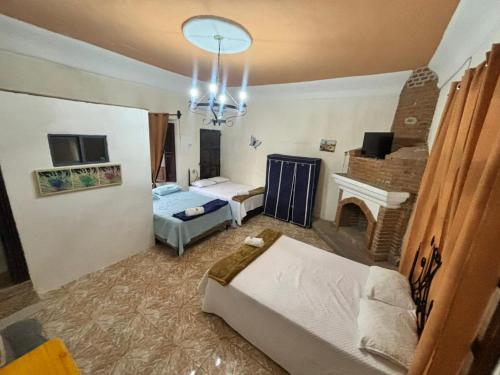 a living room with a bed and a fireplace at Ciudad Vieja Bed & Breakfast Hotel Casa del Turista in San Lorenzo El Cubo