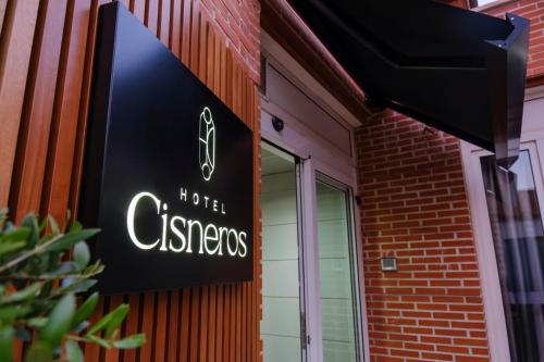 a hotel sign on the side of a building at Hotel Cisneros in Alcalá de Henares
