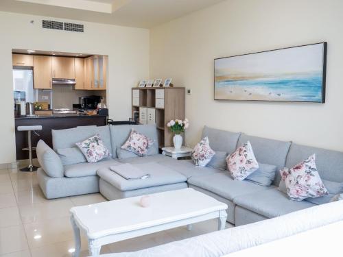 a living room with a couch and a table at Pearl Club Al Reem Island 2 Bedrooms With Pool , Gym and Tennis Court in Abu Dhabi