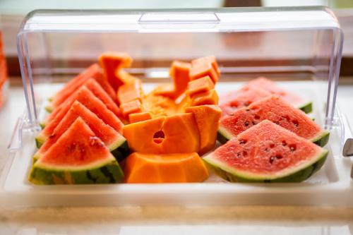 a plastic container filled with watermelon and other fruits at Pousada Café Brasil in Guaramiranga