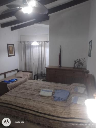 a bedroom with a large bed and a couch at Irupé in Villa Carlos Paz