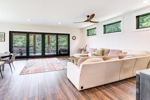 a living room with a couch and a table at Private Sauna and Dock Lakefront Retreat in Moneta! in Moneta