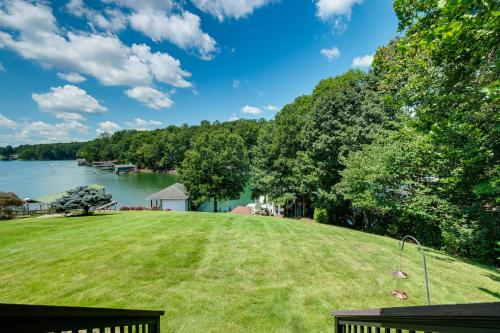 a view of a large grassy field next to a lake at Private Sauna and Dock Lakefront Retreat in Moneta! in Moneta