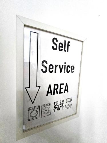 a sign that says self service area on a wall at Dacia Residence Apartments in Bucharest