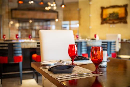 a table with two red wine glasses on it at Villa del Palmar Cancun Luxury Beach Resort & Spa in Cancún