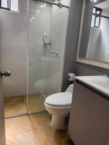 a bathroom with a shower and a toilet and a sink at Sabana Stay in Tocancipá