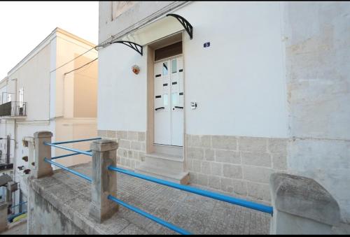 a front door of a building with blue pipes at Casa vacanza CiccioMarra in Mottola
