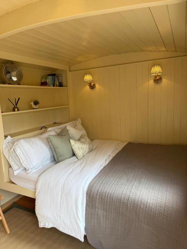 a bedroom with a large bed in a room at Cosy Shepherd Hut in Kempsford