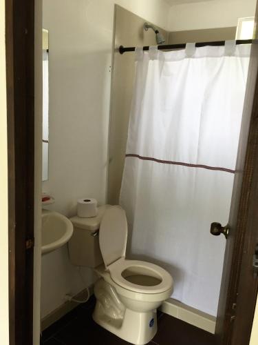 a white bathroom with a toilet and a sink at Conjunto Buganviles - Casa No 7 o 3 in Girardot