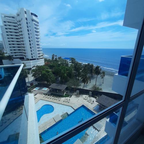 a view of the ocean from the balcony of a resort at Reserva Del Mar Apartamentos in Gaira