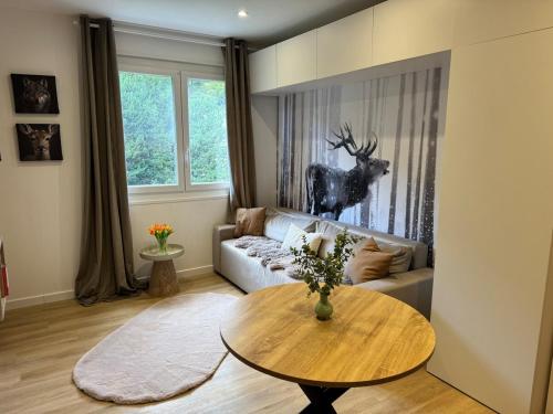 a living room with a couch and a table at Studio le Grand Cerf in Les Angles