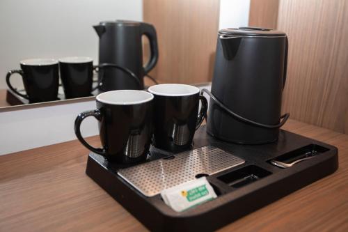 a tray with two coffee cups on a table at Villa Klaus Hotel in Tirana