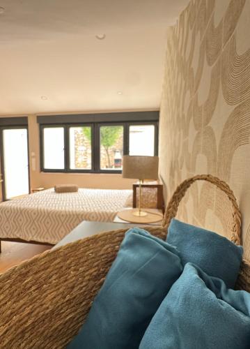 a bedroom with a bed with a blue pillow on it at Casa Rosa in Setúbal
