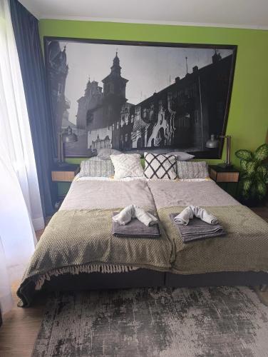 a bedroom with a large bed with towels on it at Apartament Przemyśl in Przemyśl