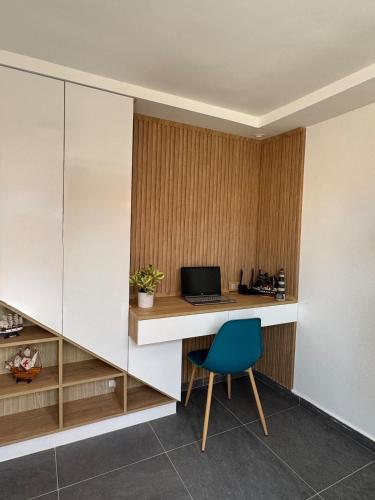 a room with a desk with a laptop and a chair at Coastal Charm Stay - sunny, calm spacious in Sidi Ifni