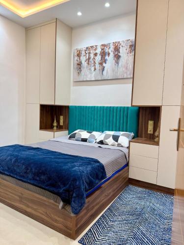 a bedroom with a large bed with a blue blanket at Coastal Charm Stay - sunny, calm spacious in Sidi Ifni