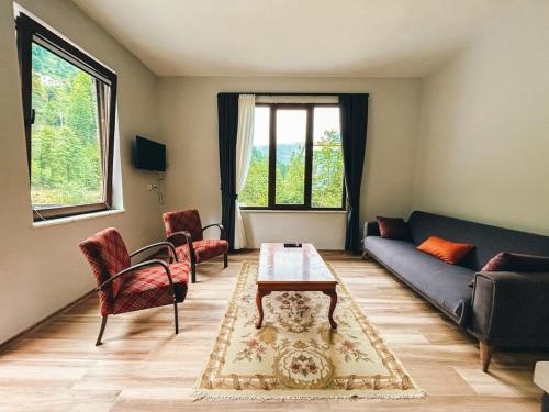 a living room with a couch and a table at A Peaceful Base for Exploring the Magic of Rize in Dikkaya