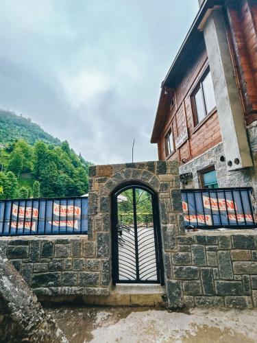 a stone building with a door and a window at A Peaceful Base for Exploring the Magic of Rize in Dikkaya