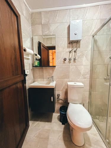 a bathroom with a toilet and a sink and a shower at A Peaceful Base for Exploring the Magic of Rize in Dikkaya