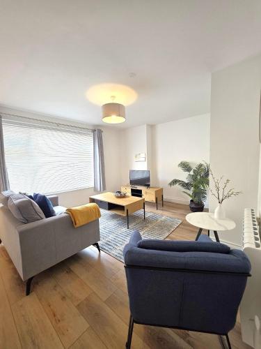 a living room with a couch and a table at Stunning One Bed Flat at Dawe Luxury Suites - An Entire Apartment near Ely Cathedral & Train Station - The Perfect Base to Explore Ely, Cambridge, Norfolk & London - 2 Guests Max in Ely