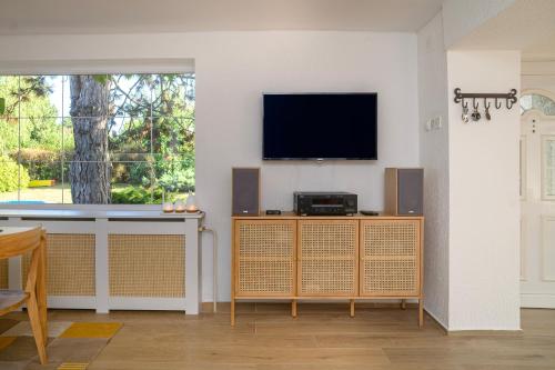 a living room with a tv on a wall at Kings Hill - Familly Retreat in Sremski Karlovci
