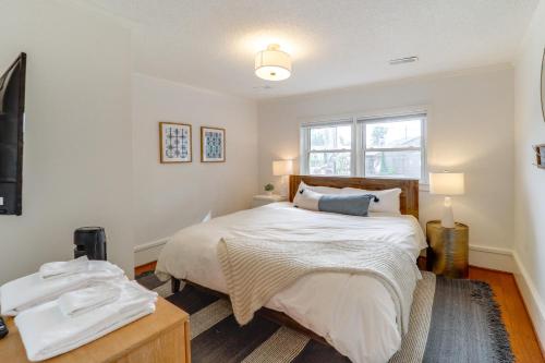 a bedroom with a large bed and a window at Shop, Dine and Unwind Dtwn Blowing Rock Retreat! in Blowing Rock