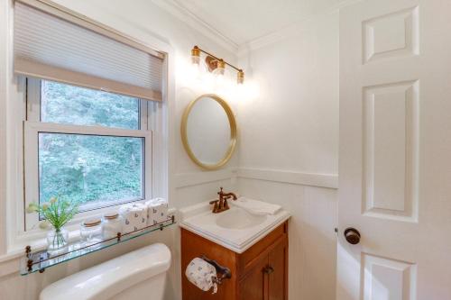 a bathroom with a sink and a mirror and a window at Shop, Dine and Unwind Dtwn Blowing Rock Retreat! in Blowing Rock