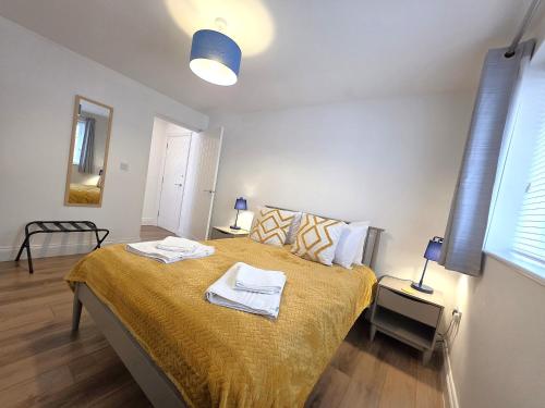 a bedroom with a bed with two towels on it at Stunning One Bed Flat at Dawe Luxury Suites - An Entire Apartment near Ely Cathedral & Train Station - The Perfect Base to Explore Ely, Cambridge, Norfolk & London - 2 Guests Max in Ely