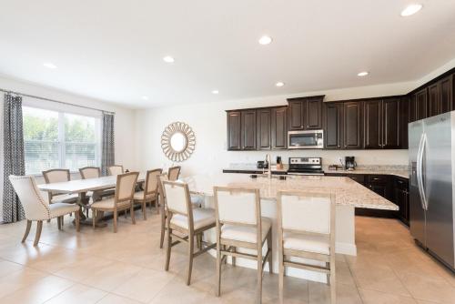 a large kitchen with a table and chairs at Lovely Home With Private Pool And Air Hockey Table Near Disney With Waterpark & Resort Access At Encore Resort - 7467Mr in Kissimmee