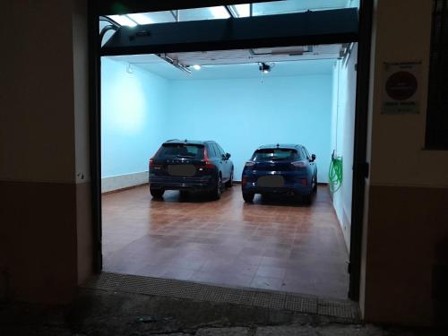 two cars are parked in a garage at Macarena Suites in Cáceres