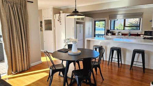 a dining room and kitchen with a table and chairs at Osier Oasis, walk to Mission & Wineries! in Napier