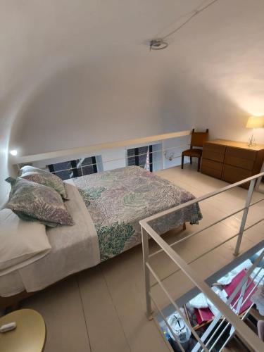 a bedroom with a bed and a table and a chair at Casa Ludovica in Catania