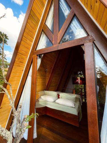 En eller flere senge i et værelse på Pousada paz e tranquilidade Chalé Lua Cheia