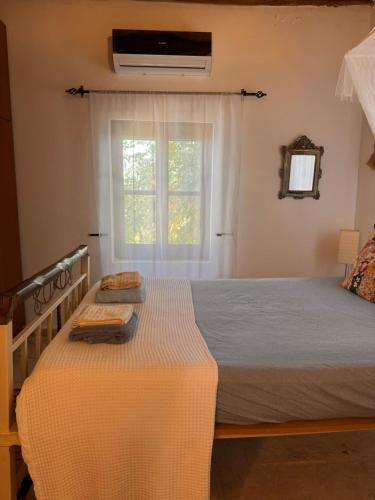 a bedroom with a bed and a window at A historic STONE VILLA with private garden, terrace and private pool just for you in Kliru