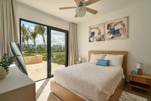 a bedroom with a bed and a large window at Luxury Escape Private Jacuzzi, Beach, Punta Cana SLEEP 5 in Punta Cana