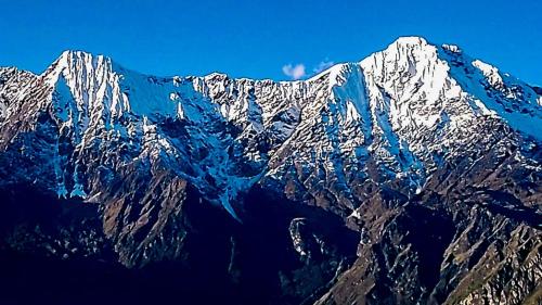 a mountain range with snow covered mountains at Inka Dream in Cachora