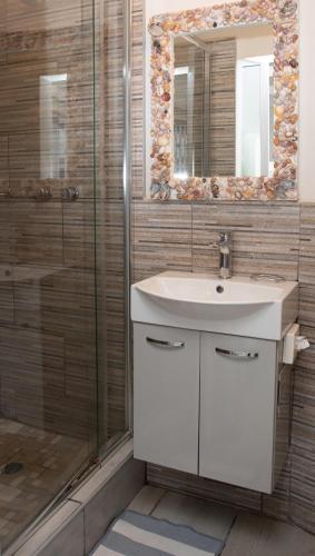 a bathroom with a sink and a shower at Sea Cottage in Port Shepstone
