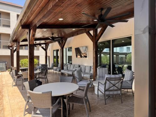 a patio with chairs and tables and a ceiling fan at Courtyard by Marriott Waco in Waco