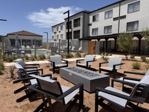 a group of chairs and a table in front of a building at Courtyard by Marriott Waco in Waco