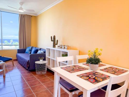 a living room with a table and a couch at Piso los Agaves in Costa de Adeje
