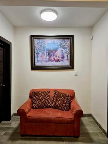 a couch in a room with a painting on the wall at New Fully Furnished Vacation House in San Felipe