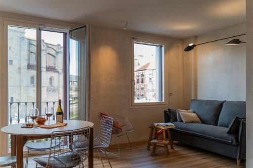 a living room with a couch and a table at Enea Living in Bilbao