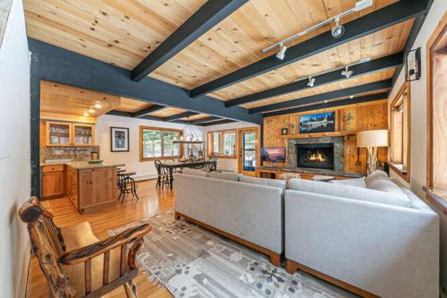 a living room with a couch and a fireplace at Lakewalk Lodge at the West Shore by Tahoe Getaways, Pet-Friendly w Sauna! in Homewood