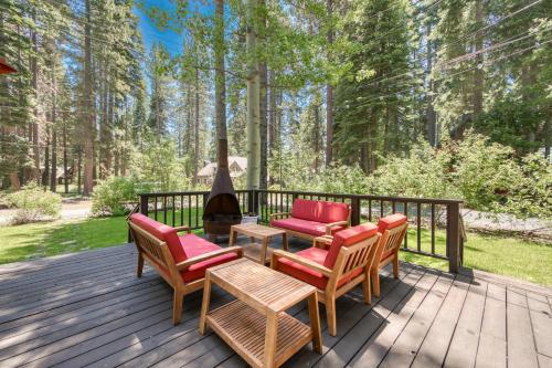 a deck with chairs and a table and a grill at Lakewalk Lodge at the West Shore by Tahoe Getaways, Pet-Friendly w Sauna! in Homewood
