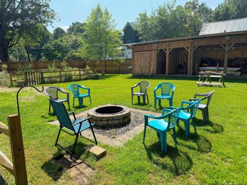 a group of chairs sitting around a fire pit at 91M Renovated Bethlehem home with hot tub, firepit, large yard, walk to restaurants in Bethlehem