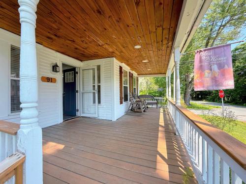 a porch of a house with a wooden ceiling at 91M Renovated Bethlehem home with hot tub, firepit, large yard, walk to restaurants in Bethlehem