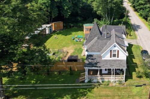 an aerial view of a house with a yard at 91M Renovated Bethlehem home with hot tub, firepit, large yard, walk to restaurants in Bethlehem