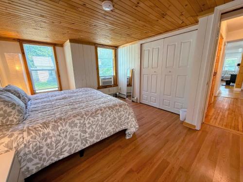 a bedroom with a bed and a wooden ceiling at 91M Renovated Bethlehem home with hot tub, firepit, large yard, walk to restaurants in Bethlehem
